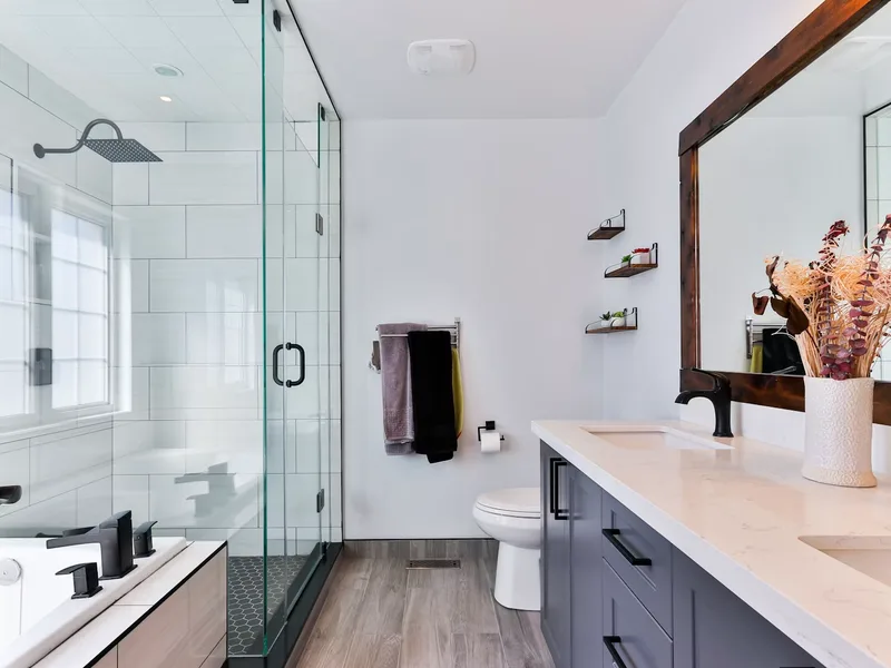 Polished chrome bathroom mixer faucet and clean white ceramic sink basin